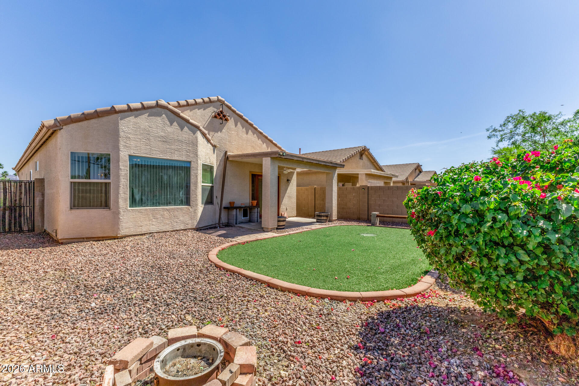 256 North 110th Street Apache Junction, AZ 85120 - Photo 25 of 27 a view of a white house with a big yard and potted plants