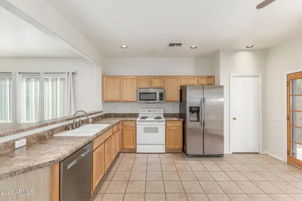 a kitchen with a sink stove and refrigerator