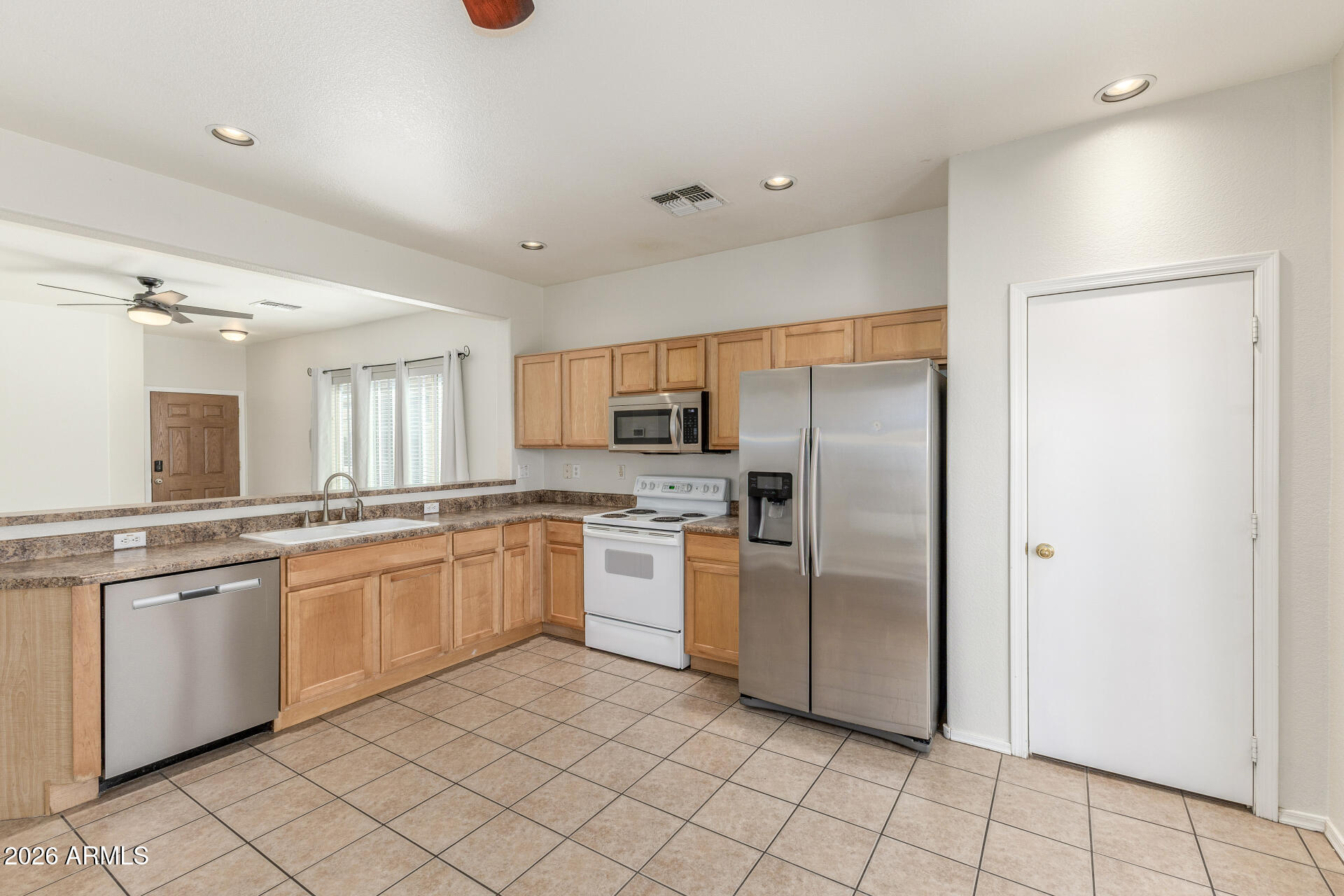 256 North 110th Street Apache Junction, AZ 85120 - Photo 10 of 27 a kitchen with stainless steel appliances granite countertop a refrigerator and a sink