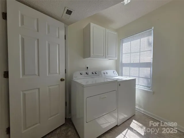 a room with a sink cabinets and utility room