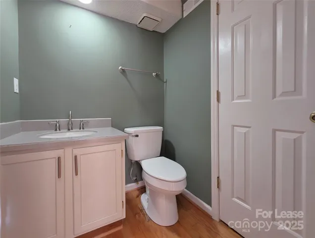 a bathroom with a toilet sink and vanity