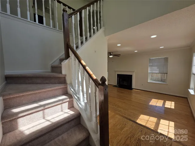 a view of entryway and hall with wooden floor
