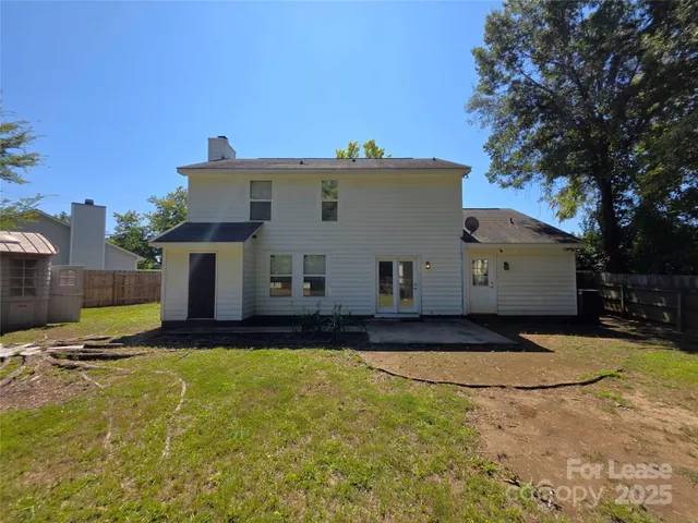 a view of a white house with a yard