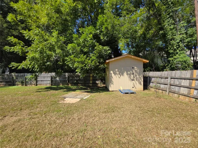 a white house that has a tree in front of it