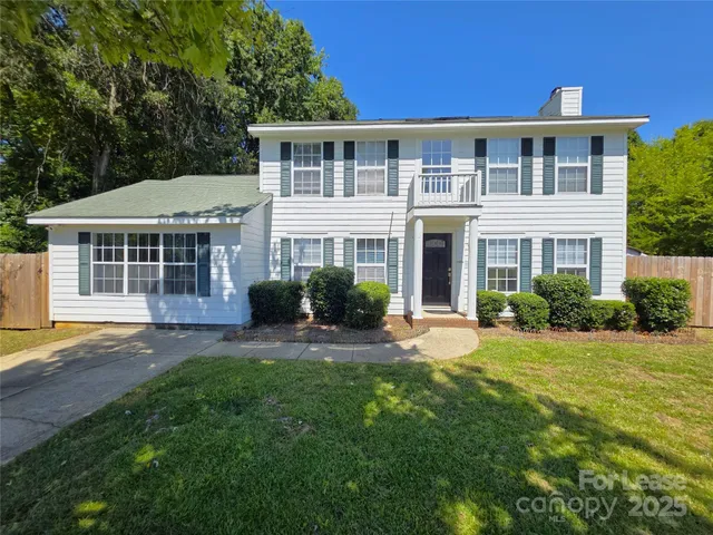 a front view of a house with a yard and porch
