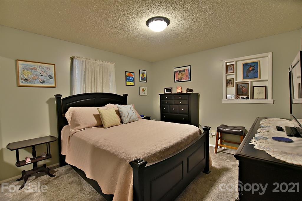 407 Laurel Hills Road Indian Land, SC 29707 - Photo 16 of 26 a bedroom with a bed and wooden floor