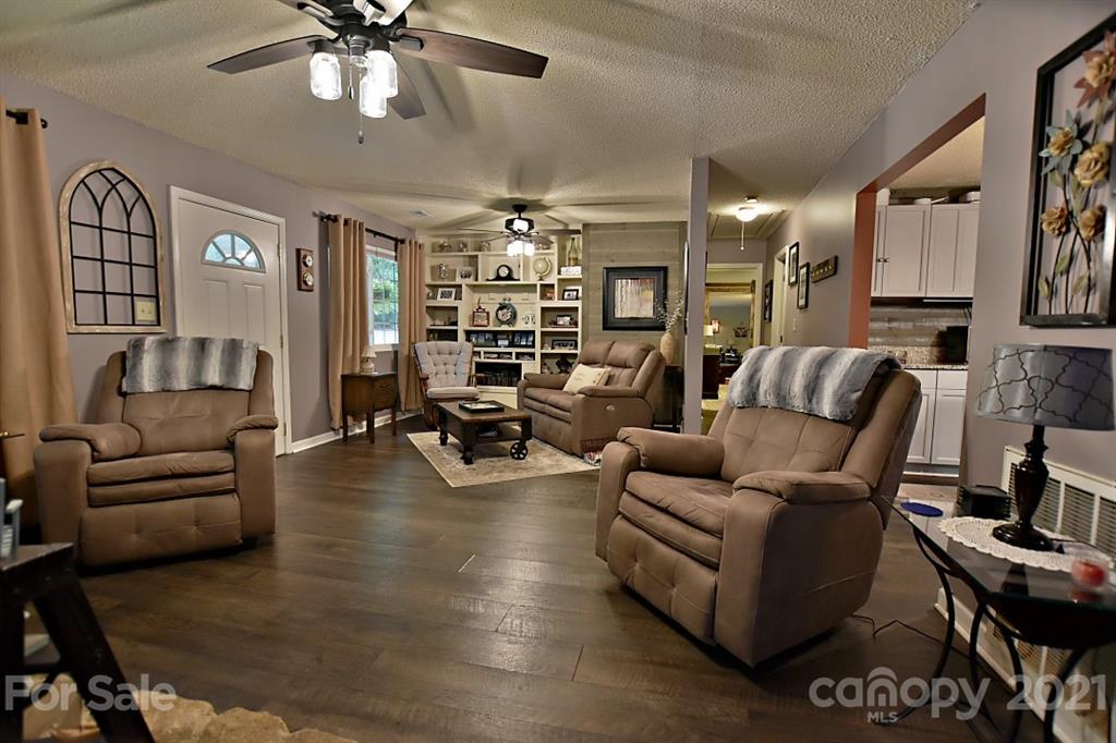 407 Laurel Hills Road Indian Land, SC 29707 - Photo 3 of 26 a living room with furniture and a chandelier