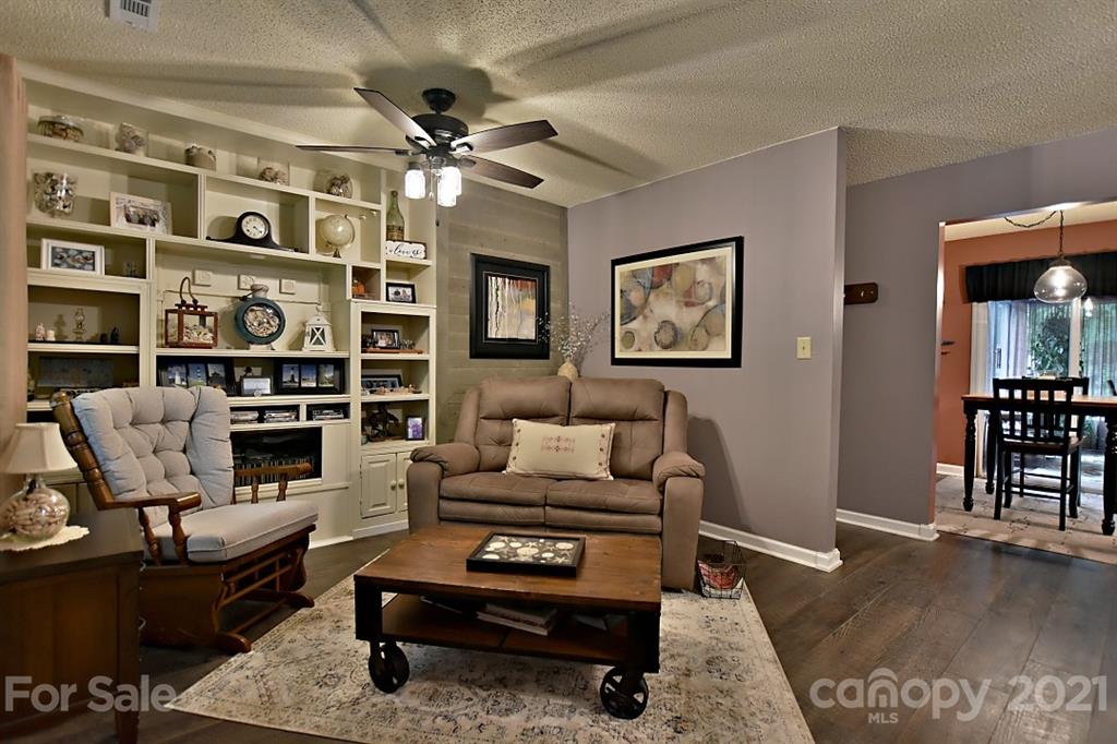 407 Laurel Hills Road Indian Land, SC 29707 - Photo 4 of 26 a living room with furniture a rug and a bookshelf