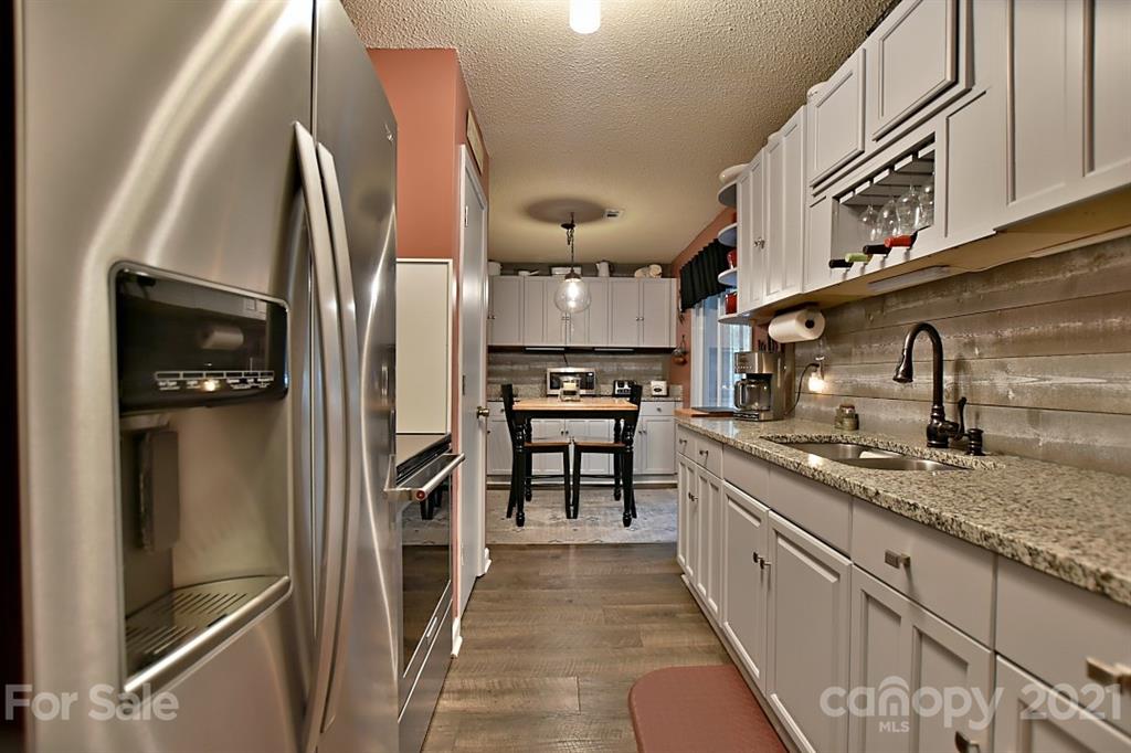 407 Laurel Hills Road Indian Land, SC 29707 - Photo 7 of 26 a kitchen with stainless steel appliances granite countertop a refrigerator and a sink