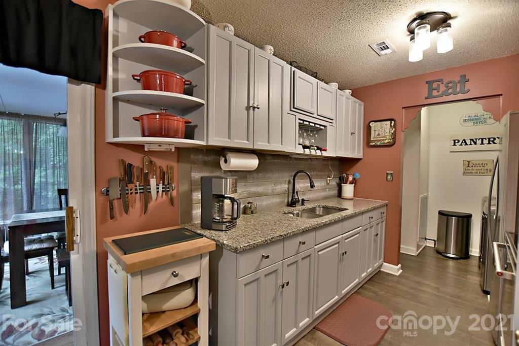 407 Laurel Hills Road Indian Land, SC 29707 - Photo 8 of 26 a kitchen with stainless steel appliances granite countertop a stove a sink and cabinets