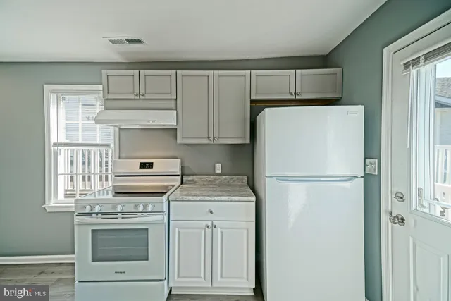 a white refrigerator freezer and a stove top oven