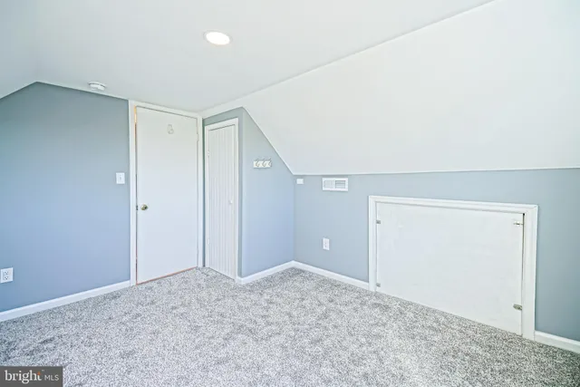 a view of residential houses with outdoor space and parking