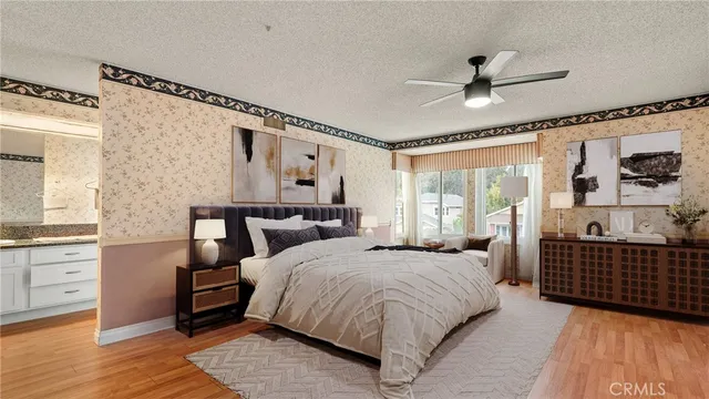 a bedroom with a bed and wooden floor