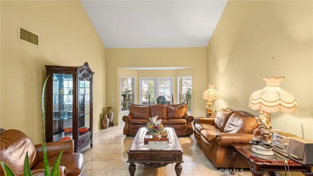 a living room with furniture fireplace and a large window
