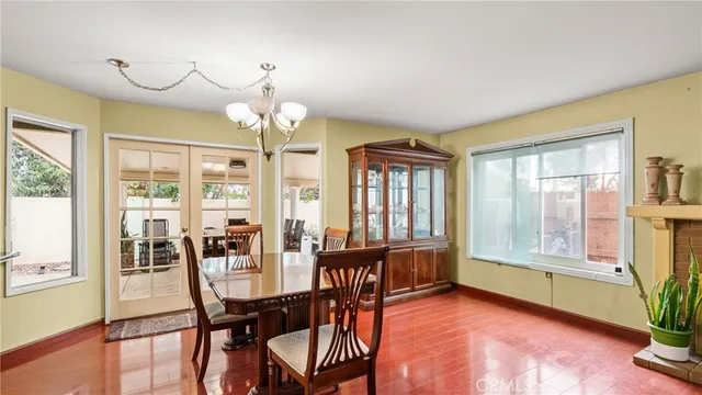 a view of a dining room with furniture large windows and wooden floor