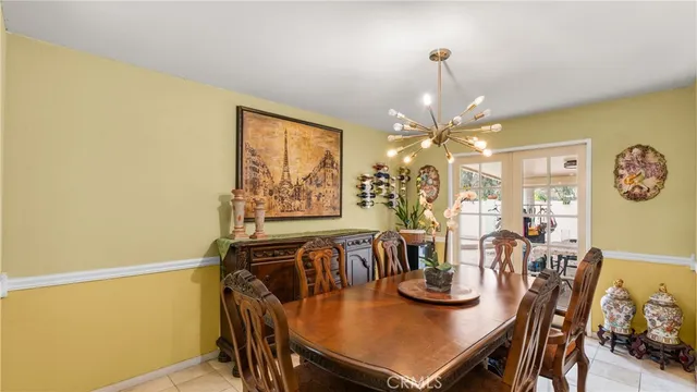 a view of a dining room with furniture and chandelier