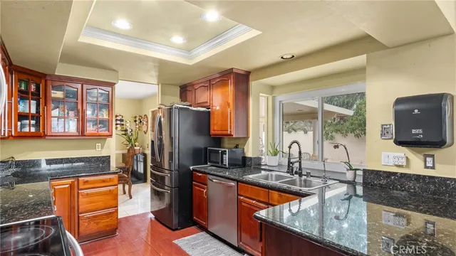 a kitchen with stainless steel appliances granite countertop a sink stove and refrigerator