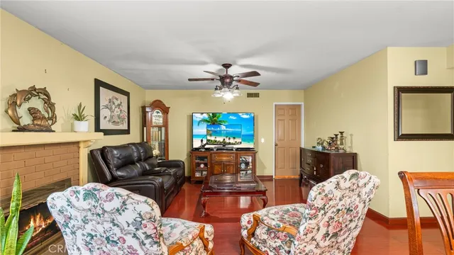 a living room with furniture a chandelier and a flat screen tv