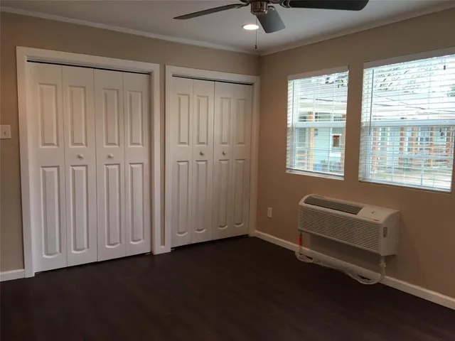 an empty room with a hardwood and a window
