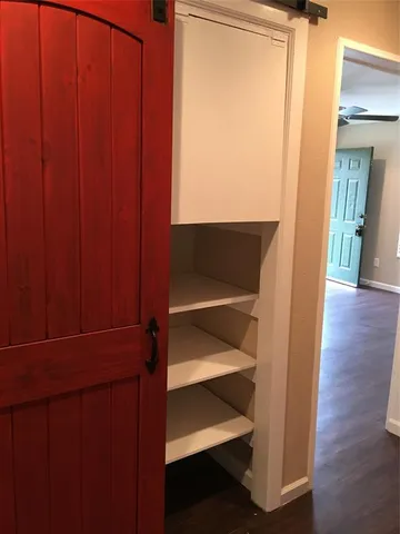 a view of walk in closet with empty racks