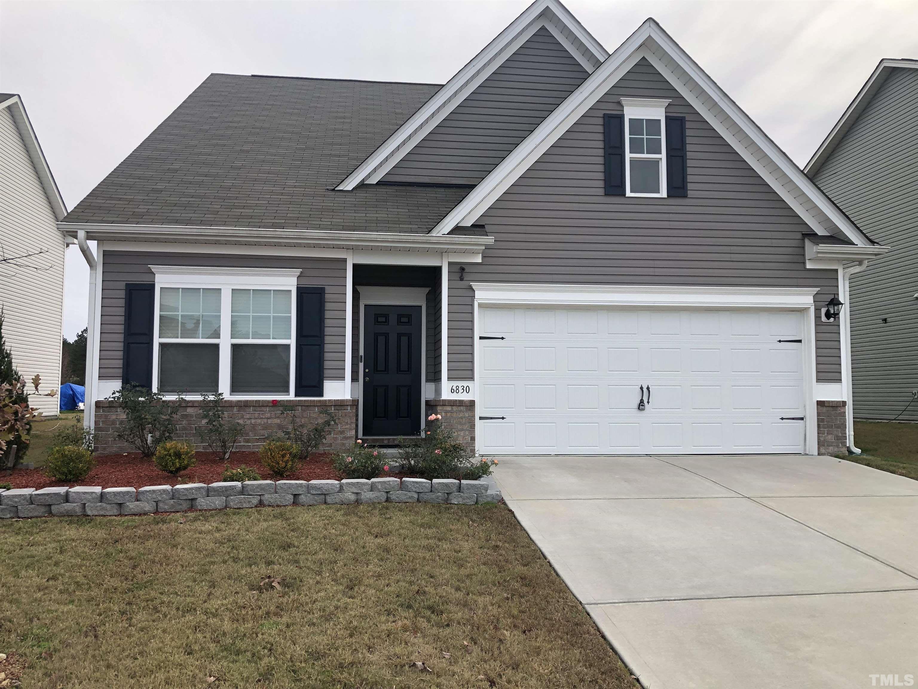 6830 Resting Grove Road Raleigh, NC 27610 - Photo 1 of 20 a front view of a house with garden