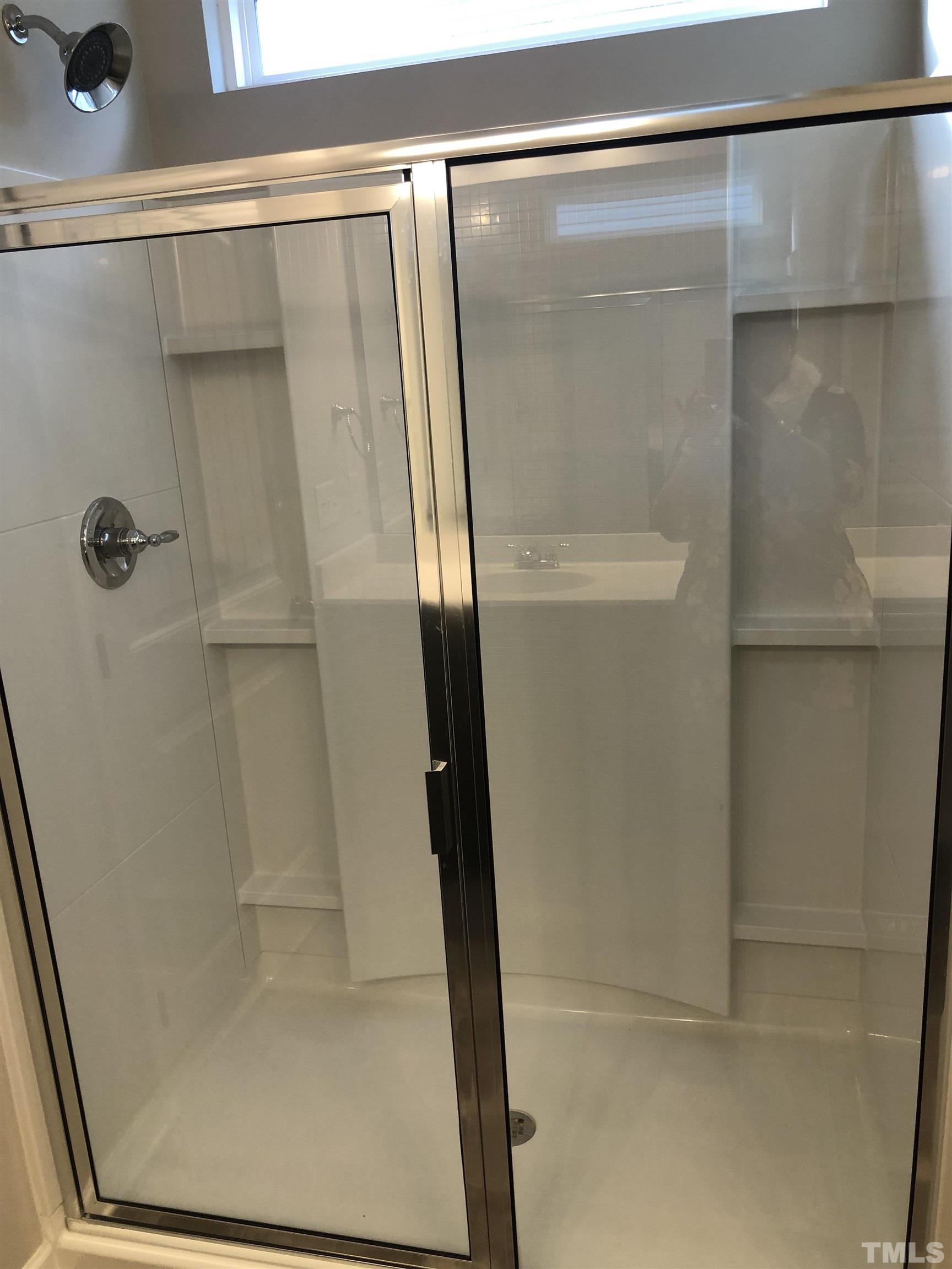 6830 Resting Grove Road Raleigh, NC 27610 - Photo 13 of 20 a bathroom with a glass shower door