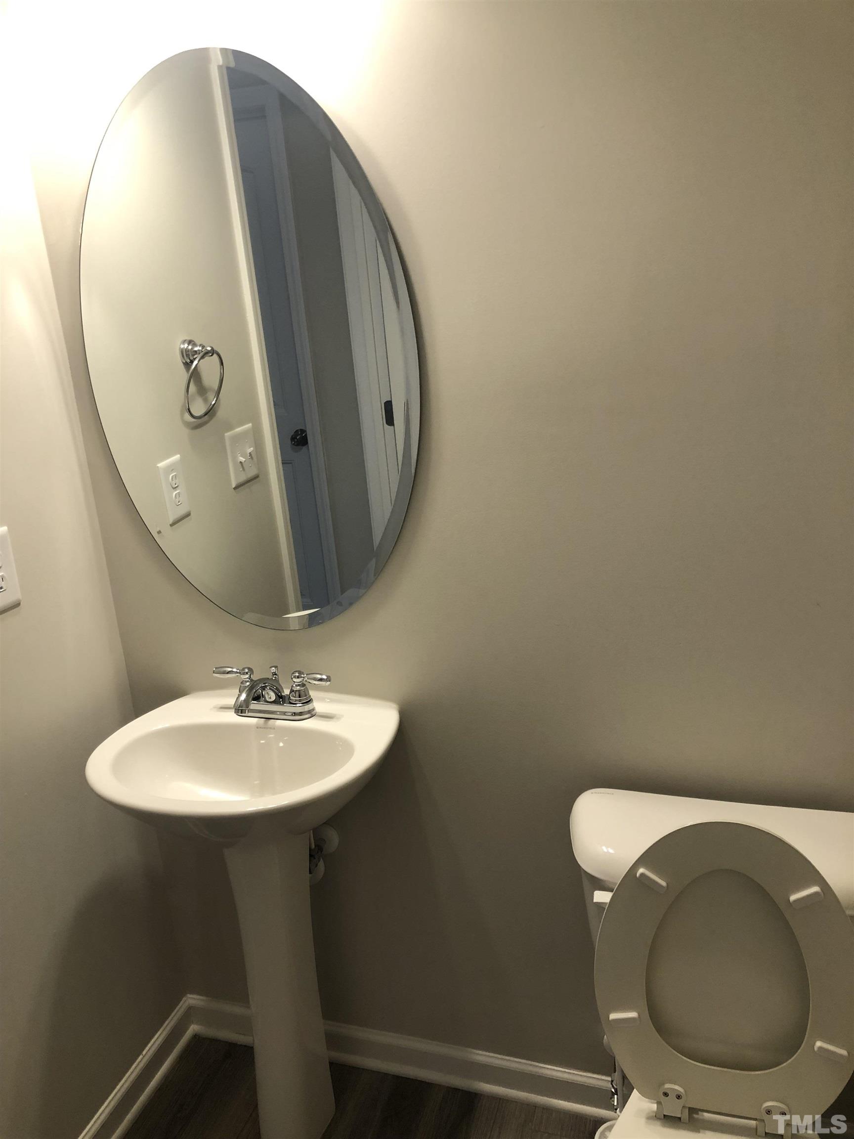 6830 Resting Grove Road Raleigh, NC 27610 - Photo 14 of 20 a bathroom with a toilet sink and mirror