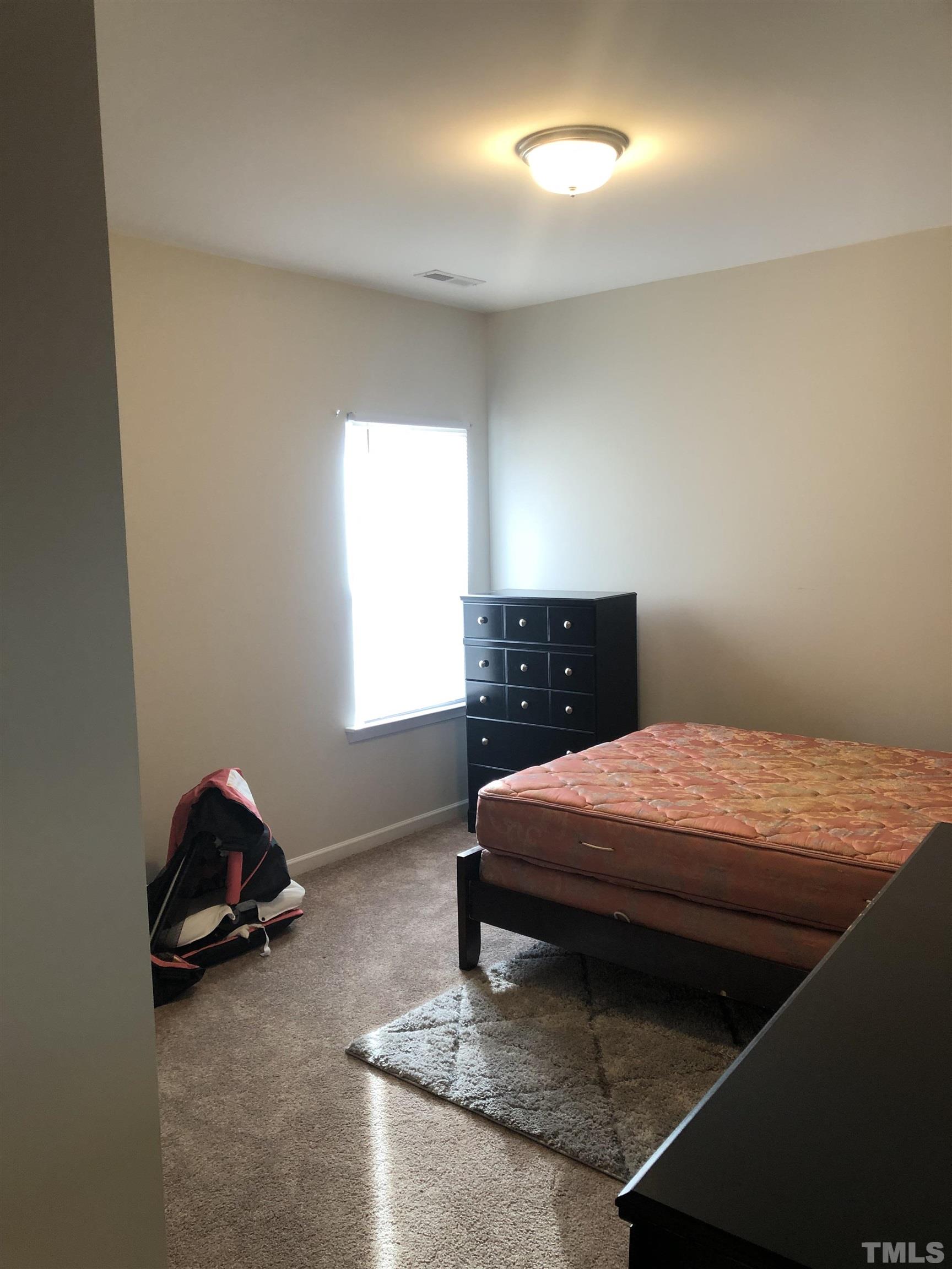 6830 Resting Grove Road Raleigh, NC 27610 - Photo 17 of 20 a bedroom with a bed and window