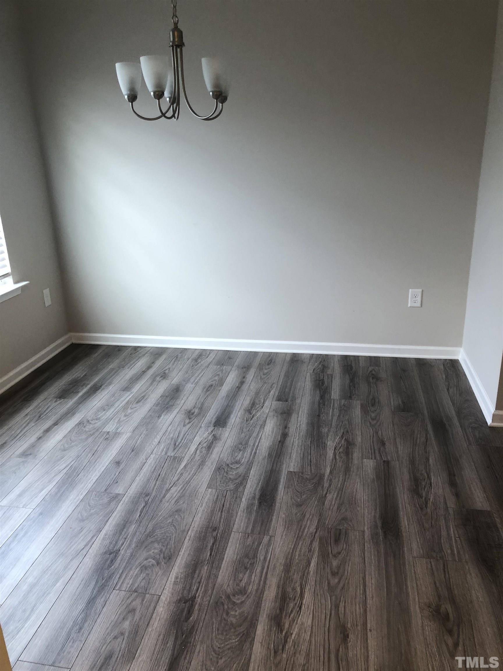 6830 Resting Grove Road Raleigh, NC 27610 - Photo 20 of 20 a view of an empty room with wooden floor and a window