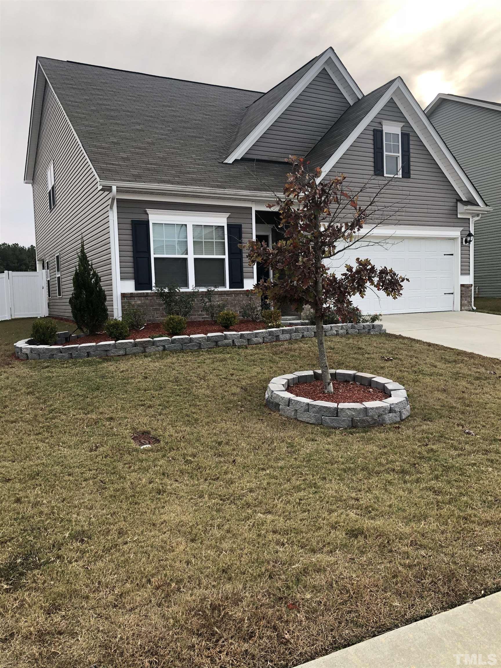 6830 Resting Grove Road Raleigh, NC 27610 - Photo 2 of 20 a view of a house with a yard
