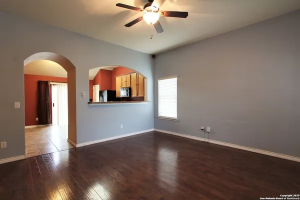 wooden floor in an empty room with a window