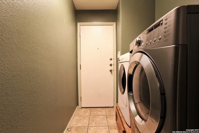 a view of a storage and utility room with washer and dryer