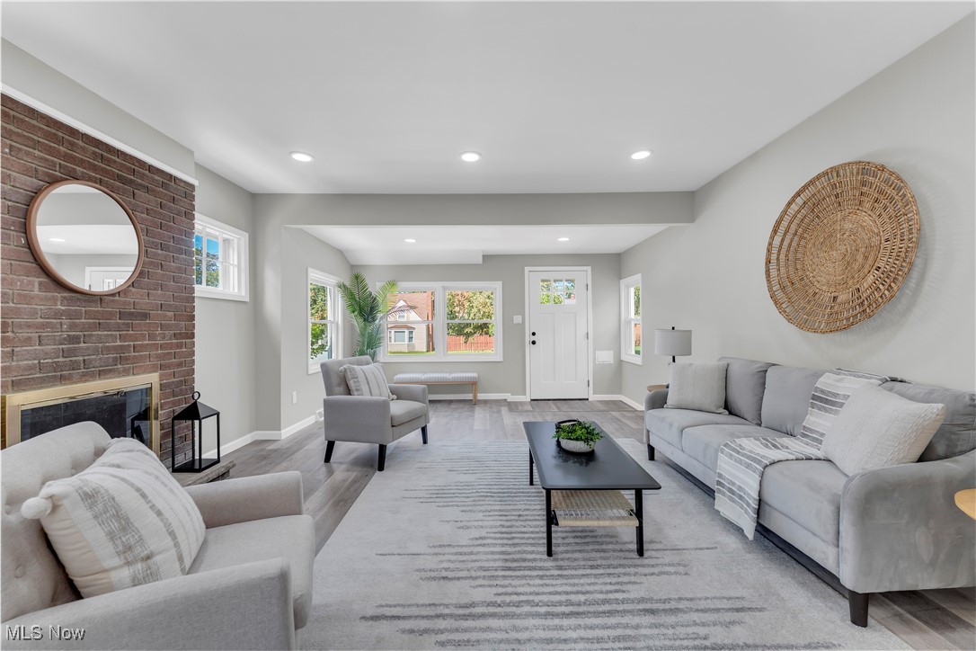 4124 Bayard Road Cleveland, OH 44121 - Photo 6 of 35 Living area featuring recessed lighting, a brick fireplace, and wood finished floors
