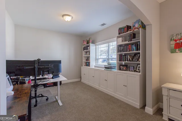 a bathroom with a granite countertop bathtub a sink and a mirror