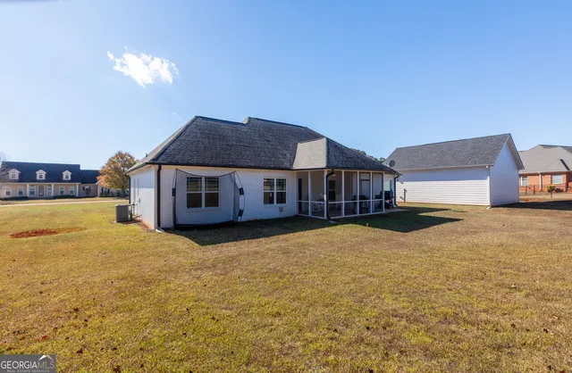 a view of beach and small yard