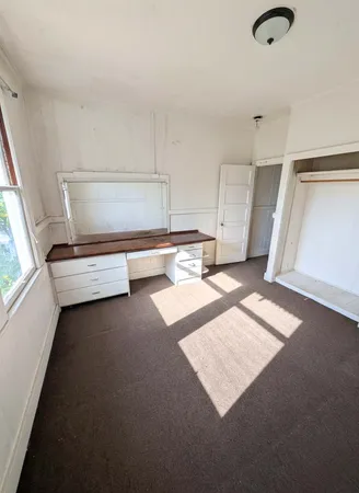 a view of an empty room with windows