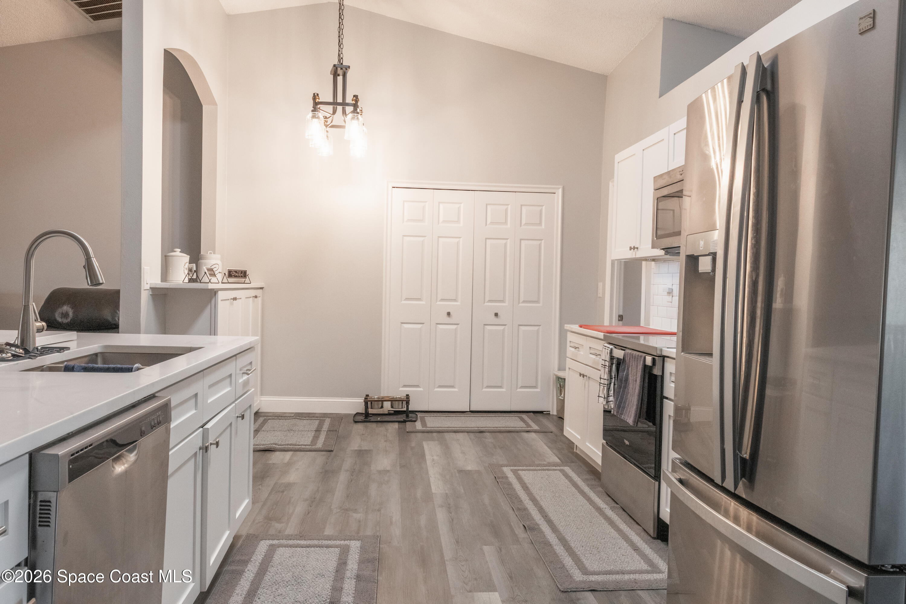 7210 Barbara Road Cocoa, FL 32927 - Photo 6 of 8 a view of a kitchen with a sink and refrigerator