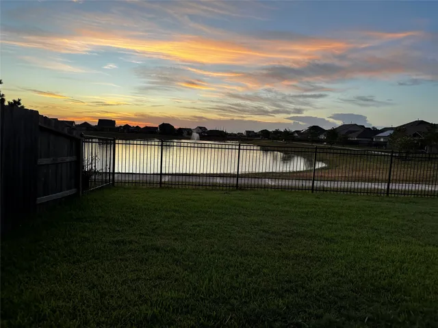 a view of a lake with a house in the background