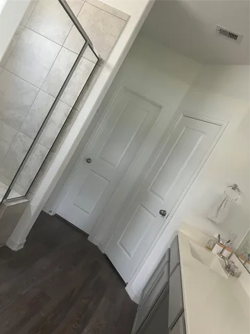 a bathroom with a bathtub and shower