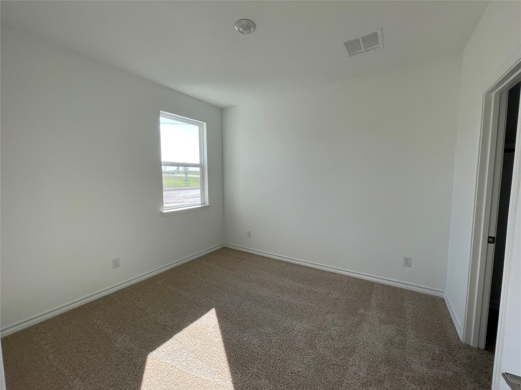 101 Thurman Holt Road Hutto, TX 78634 - Photo 11 of 38 an empty room with a window