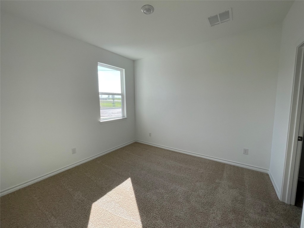 101 Thurman Holt Road Hutto, TX 78634 - Photo 12 of 38 an empty room with a window