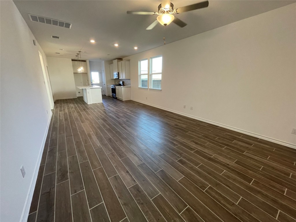 101 Thurman Holt Road Hutto, TX 78634 - Photo 16 of 38 a view of empty room with wooden floor