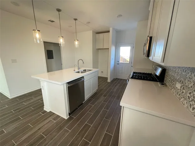 an empty room with a window and a ceiling fan