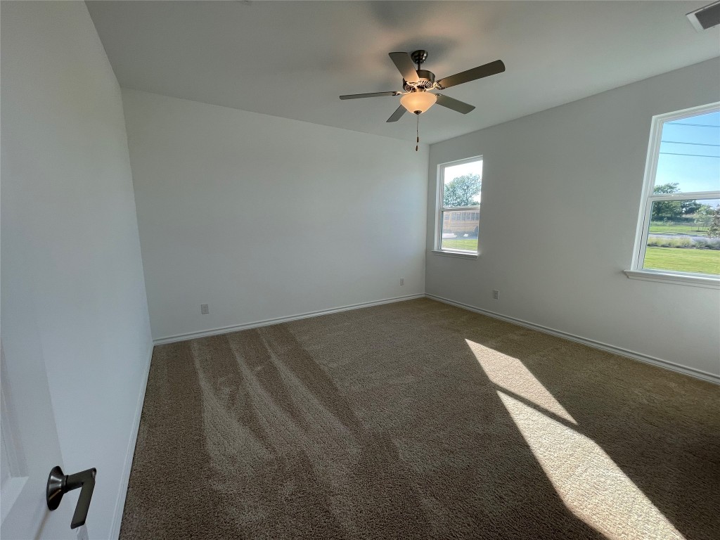 101 Thurman Holt Road Hutto, TX 78634 - Photo 20 of 38 wooden floor in an empty room with a window