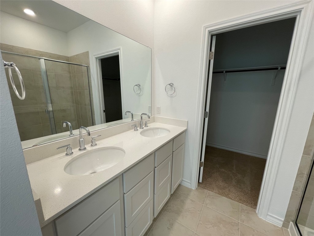101 Thurman Holt Road Hutto, TX 78634 - Photo 21 of 38 a bathroom with a sink and mirror