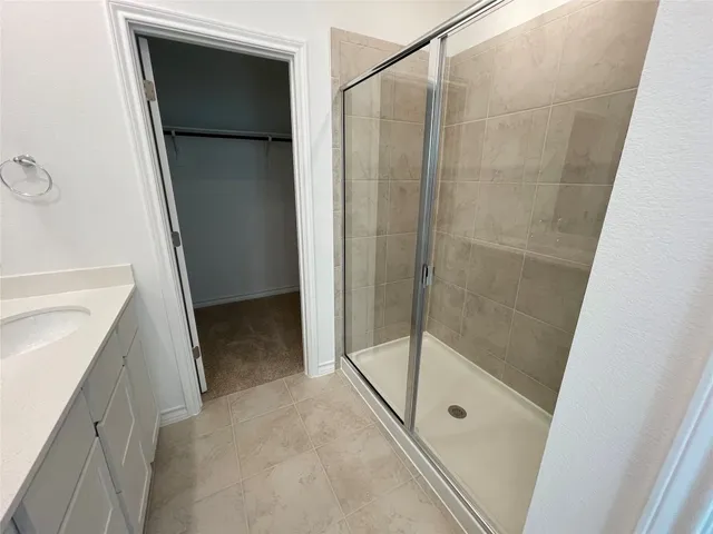 a white toilet sitting next to a wooden floor