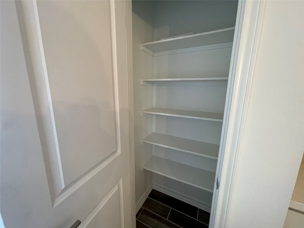 101 Thurman Holt Road Hutto, TX 78634 - Photo 36 of 38 a view of walk in closet with empty racks