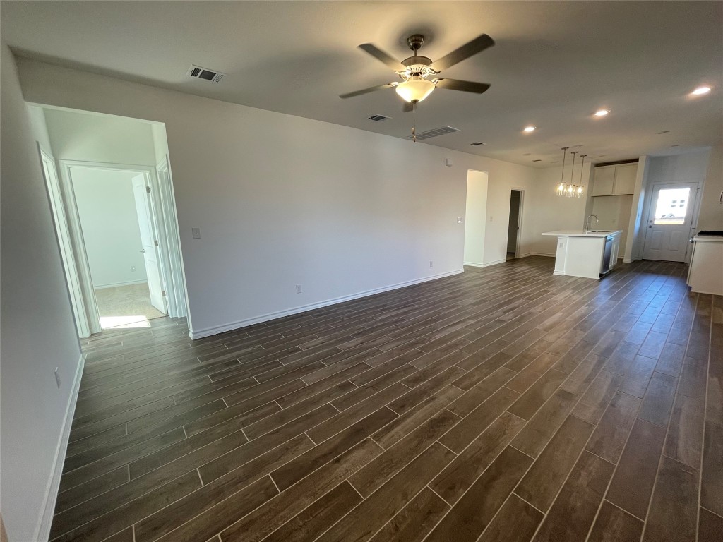 101 Thurman Holt Road Hutto, TX 78634 - Photo 7 of 38 a view of a room with wooden floor and ceiling fan