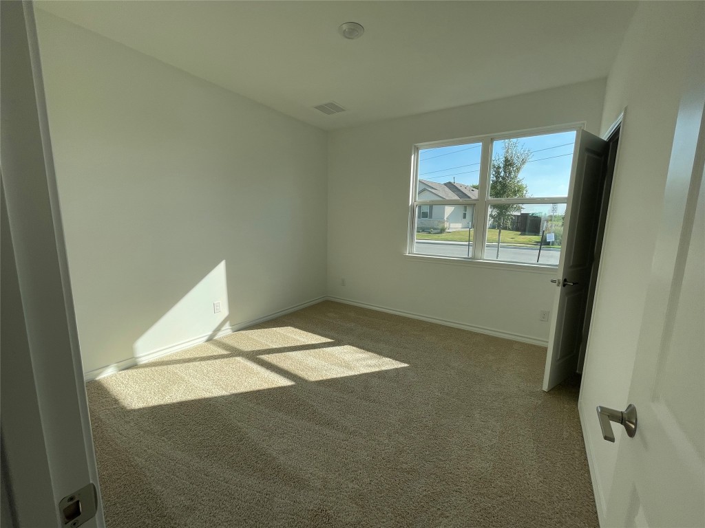 101 Thurman Holt Road Hutto, TX 78634 - Photo 9 of 38 a view of an empty room with a window