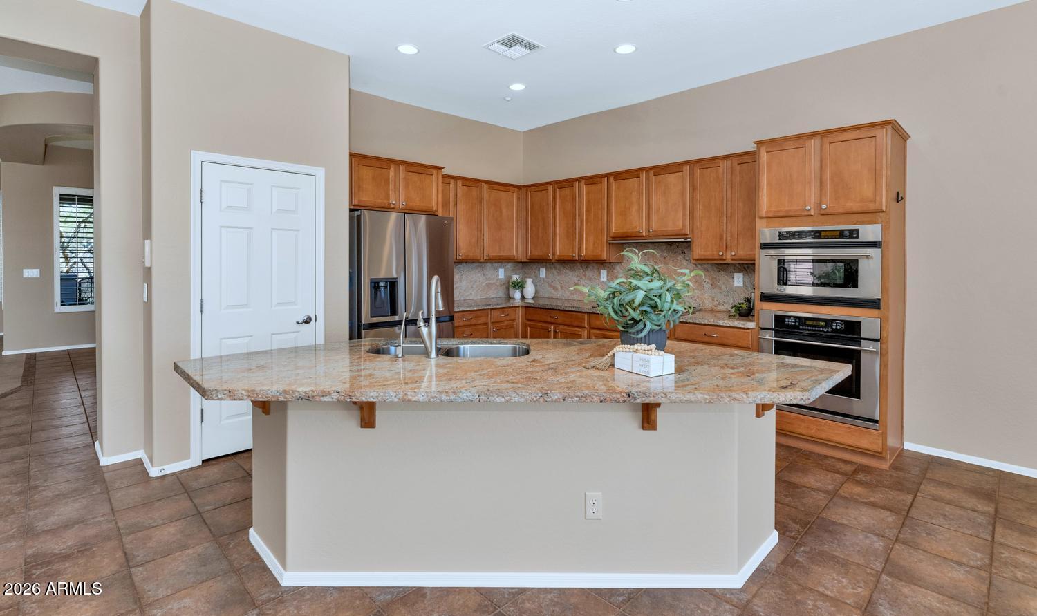 41123 North River Bend Road Phoenix, AZ 85086 - Photo 10 of 45 a kitchen with kitchen island granite countertop a white counter top stainless steel appliances and cabinets
